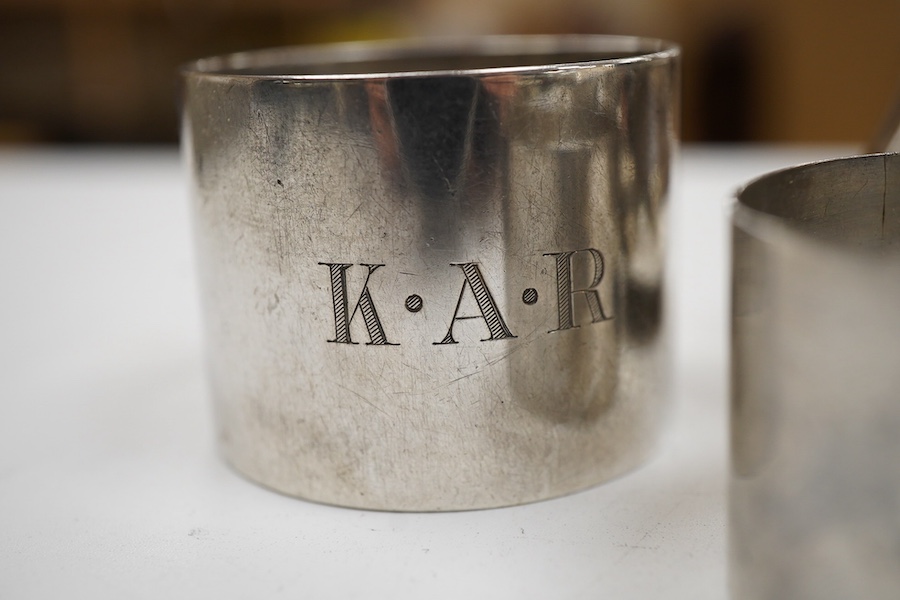 A George V silver three piece condiment set by Walker & Hall, Sheffield, 1921, together withy two other silver condiments, three assorted silver condiment spoons and four assorted silver napkin rings.